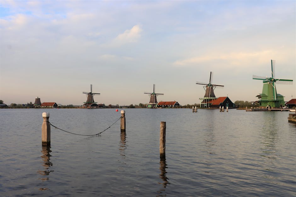 Picturesque scene of traditional Dutch windmills along the waterside at Zaanse Schans, Netherlands.